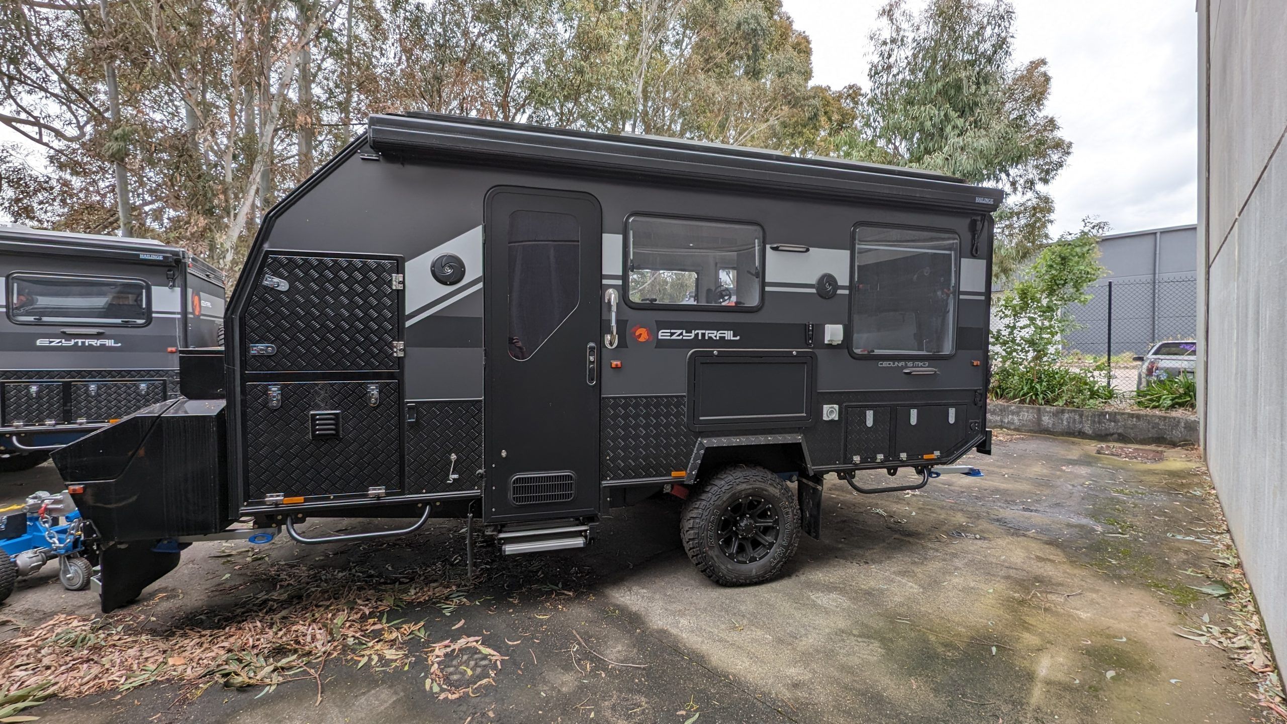 Side view of a black Ceduna 15 Twin MK3 Caravan