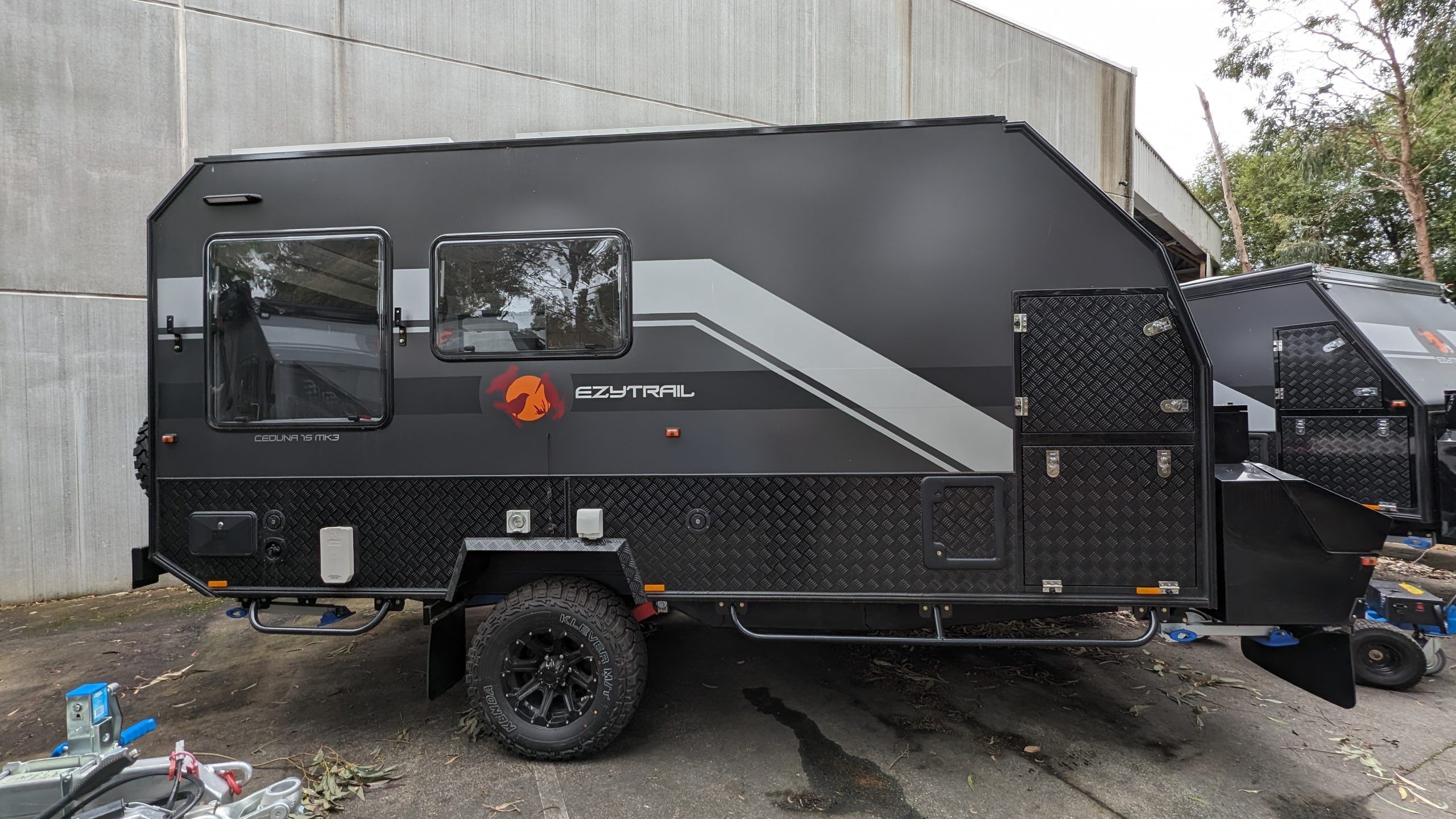 Side view of a black Ceduna 15 Twin MK3 Caravan