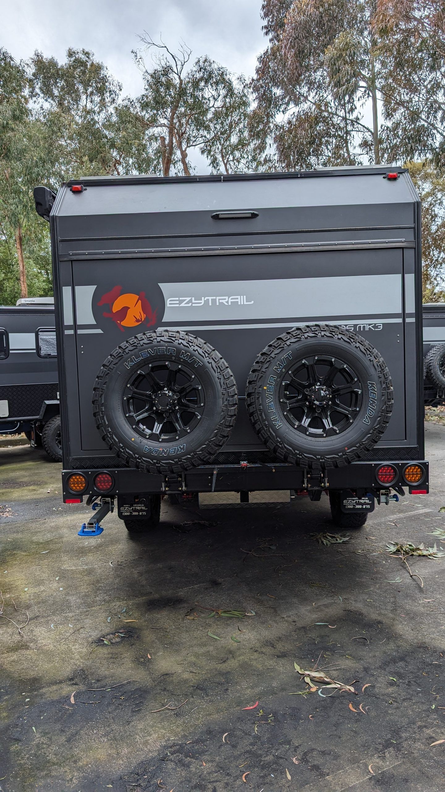 Rear view of a black Ceduna 15 Twin MK3 Caravan